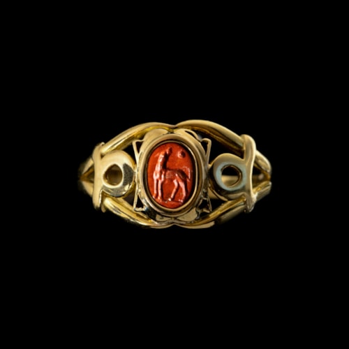 A modern gold ring set with a Roman red jasper intaglio. Dog.